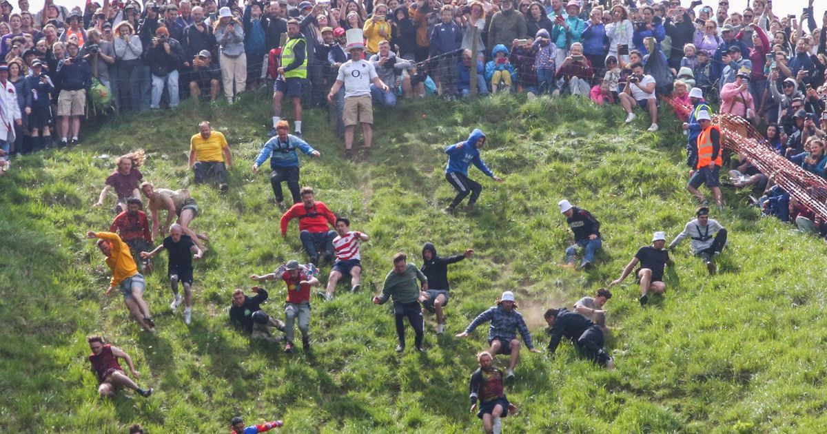 Rolling thunder: Contestants chase cheese wheel down a hill in chaotic UK  race