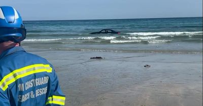 Flashy BMW convertible swept out to sea after being parked on beach