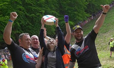 Woman wins UK cheese rolling race despite being knocked unconscious