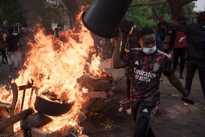 Police fire tear gas and protestors burn vehicles near home of Senegal's main opposition leader