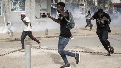 Police fire tear gas, protesters burn cars near home of Senegal's main opposition leader