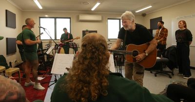William Crighton and John Schumann making music with inmates at Cessnock jail