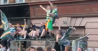 Two Celtic fans plunge through bus stop roof at title party in Glasgow
