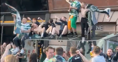 Celtic fans filmed crashing through bus stop roof during trophy celebrations at Glasgow Cross