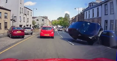 Horrifying moment car 'with mum and daughter inside' flips on Scots high street