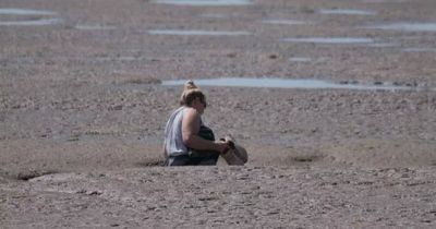 Woman has to be rescued after getting stuck in the mud at popular beach