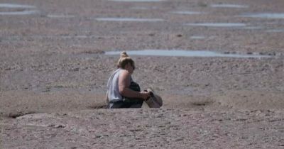 Unlucky woman gets stuck up to waist in MUD - and has to be dramatically rescued