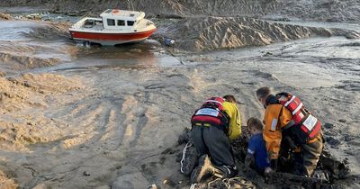 Young boy gets trapped in waist-deep mud while walking dog on the beach