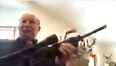 Court: No lawsuit immunity for Michigan official who had rifle during online meeting