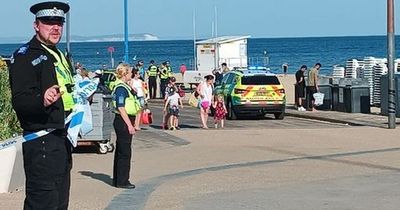 Girl, 12, and teen boy die after getting into difficulty at beach as man arrested