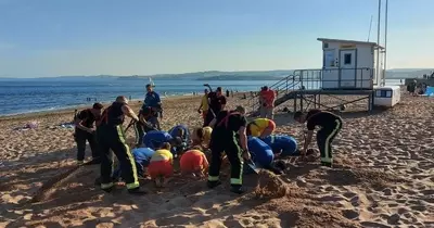 Boy almost buried alive on West Country beach after getting stuck in sand