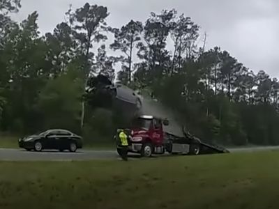 A driver's car soared 120 feet after vaulting off of a tow truck's ramp in Georgia