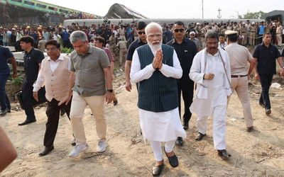 Modi visits train crash site, as signals failure suspected