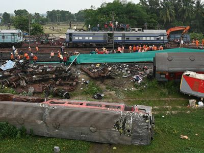 A man searches desperately for his nephew, who is missing after India's train crash