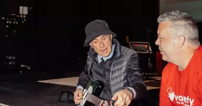 Status Quo legend Francis Rossi signs guitar for charity auction at Bristol gig