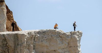 UK tourists defy 'Do Not Pass' sign to take photos on 150ft cliff prone to rock falls