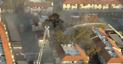 Fire rips through apartment building in Las Vegas valley as huge plumes of smoke circle area