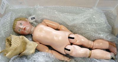 Dog-chewed doll saved from skip fetches £53,000 at auction