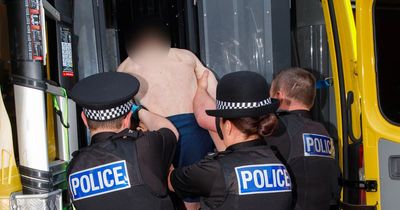 Topless man cuffed as police make arrests in 'Scouse Jonno' raids