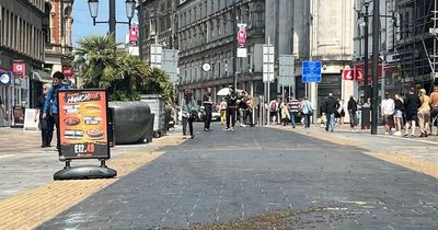 Swarm of bees land on one of Cardiff city centre's busiest streets