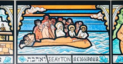 Window of slave trader replaced with multi-racial Jesus in boat with refugees