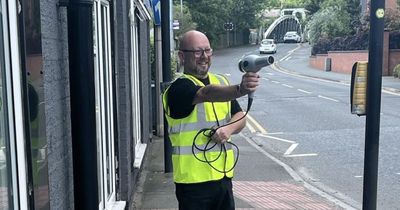 Barber cuts drivers' speed by standing in high vis pointing hairdryer at traffic