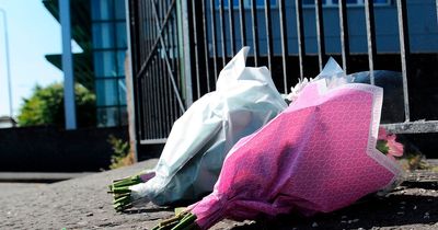 Flowers laid outside school where teen died as tributes pour in