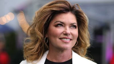 Shania Twain's tour look drives fans wild as she steps out with flowing pink hair and edgy fishnets