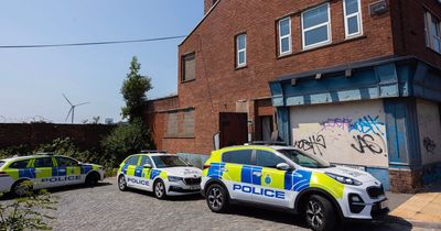 Police guard old furniture shop after report made