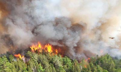 Exhausted crews battle Canadian wildfires as experts issue climate warning