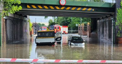 Sudden heavy rainfall leaves people trapped in submerged cars and closes lanes on motorway