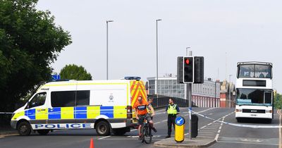 Police cordon off road after woman, 21, falls from bridge