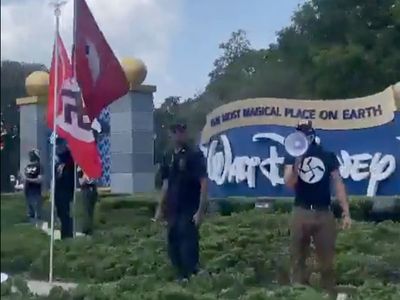 Protesters fly Nazi and DeSantis 2024 flags outside Disney World entrance