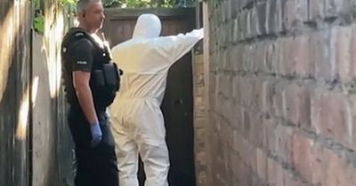 Police and forensics search back of raided Nottingham home after three killed