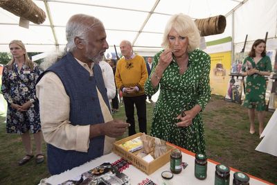 Camilla stamps ‘Queen Bee’ on paper art installation at beekeeping charity event