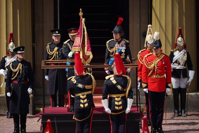 Charles presents flag to mounted cavalry ahead of first birthday parade