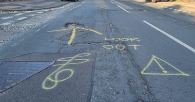 Vigilantes spray-paint F-word on road to warn drivers of giant pothole