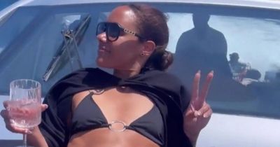 Alex Scott dazzles as she relaxes on a yacht in a tiny black bikini in Ibiza
