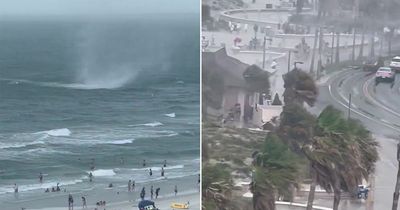 Terrifying moment beachgoers flee Florida shoreline as waterspout spins out of control