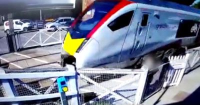 CCTV catches woman seconds from death as train hurtles past at crossing