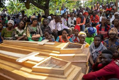 Ugandans bury more victims of horrific school massacre