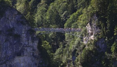 American woman shoved off bridge near German castle is released from hospital