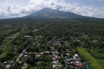 Poor villagers risk their lives in danger zone as Philippines' most active volcano erupts