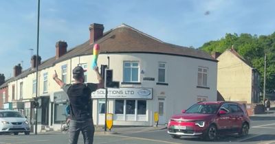 Watch: 'Hero' barber 'flamboyantly' conduct traffic with rainbow feather duster after lights fail