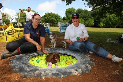 Lottery winners get stuck in creating herb garden at dog ‘retirement home’