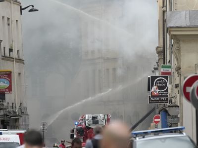 Paris police look for the cause of an explosion and fire that injured 24 people