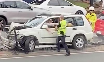 Police repeatedly punched driver following head-on crash in Brisbane, video shows