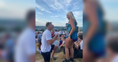 Glastonbury crowd start cheering as man gets down on one knee