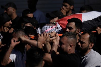 Israeli military kills Palestinian gunman as settlers rampage through Palestinian town