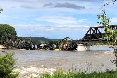 A bridge over Yellowstone River collapses, sending a freight train into the waters below
